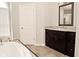 Bathroom featuring a dark vanity with granite counter and shower with glass door at 1358 Rutherglen Ct, Danville, IN 46122
