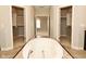 Luxurious bathroom showcasing a soaking tub and a large walk-in closet at 1358 Rutherglen Ct, Danville, IN 46122