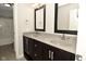 Elegant bathroom featuring a double vanity with dark wood cabinets and modern fixtures at 1358 Rutherglen Ct, Danville, IN 46122