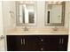 Neutral colored bathroom featuring a dual sink vanity with silver hardware and framed mirrors at 1358 Rutherglen Ct, Danville, IN 46122