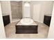Luxurious bathroom with soaking tub, walk-in shower, and dark wood cabinetry at 1358 Rutherglen Ct, Danville, IN 46122