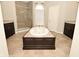 Luxurious bathroom featuring a large soaking tub, glass shower, and double vanities at 1358 Rutherglen Ct, Danville, IN 46122