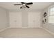 Spacious bedroom with neutral carpet and ample closet space, featuring a modern ceiling fan at 1358 Rutherglen Ct, Danville, IN 46122