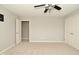 Bright bedroom with plush carpeting and a ceiling fan, adjacent to a walk-in closet at 1358 Rutherglen Ct, Danville, IN 46122