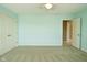 A tranquil bedroom features soft, aqua-colored walls, plush carpet, and ample closet space at 1358 Rutherglen Ct, Danville, IN 46122