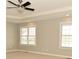 Bright bedroom featuring a tray ceiling, ceiling fan, and sun-filled windows at 1358 Rutherglen Ct, Danville, IN 46122