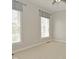 Neutral bedroom with carpet, two windows with gray curtains and ceiling fan at 1358 Rutherglen Ct, Danville, IN 46122