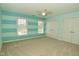 Bright bedroom with two windows, a ceiling fan, and blue accents for a refreshing and stylish look at 1358 Rutherglen Ct, Danville, IN 46122