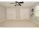 Neutral bedroom featuring two closets, a ceiling fan, and sports themed wall decor at 1358 Rutherglen Ct, Danville, IN 46122