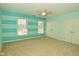 Striking bedroom with blue horizontal striped walls and a carpeted floor at 1358 Rutherglen Ct, Danville, IN 46122