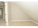 Upper bonus space with neutral carpeting and sloped ceilings, offering a flexible layout at 1358 Rutherglen Ct, Danville, IN 46122