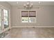 Bright dining area with tile floors, chandelier, and backyard view at 1358 Rutherglen Ct, Danville, IN 46122