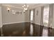 Spacious dining room showcasing hardwood floors, elegant lighting, and views of the outdoors at 1358 Rutherglen Ct, Danville, IN 46122