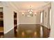 Elegant dining room with dark wood floors, chandelier and large windows for natural light at 1358 Rutherglen Ct, Danville, IN 46122