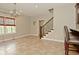 Bright dining room with a chandelier, large windows, and tile flooring leading to a staircase at 1358 Rutherglen Ct, Danville, IN 46122