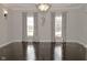 Dining room featuring hardwood floors, decorative lighting, and two large windows at 1358 Rutherglen Ct, Danville, IN 46122