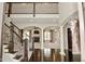 Grand foyer featuring hardwood floors, staircase, and view of living room with fireplace at 1358 Rutherglen Ct, Danville, IN 46122