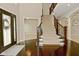 Inviting foyer with a staircase, carpeted steps and a dark wood floor and front door at 1358 Rutherglen Ct, Danville, IN 46122