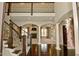 Grand foyer with dark wood floors, staircase, and views into the living room at 1358 Rutherglen Ct, Danville, IN 46122