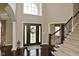 Elegant foyer with hardwood floors, large window, and staircase showcasing the home's grand entrance at 1358 Rutherglen Ct, Danville, IN 46122