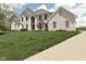 Charming two-story home with brick exterior, manicured lawn and lush landscaping at 1358 Rutherglen Ct, Danville, IN 46122