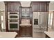 Gourmet kitchen features stainless steel appliances, including double ovens and refrigerator at 1358 Rutherglen Ct, Danville, IN 46122