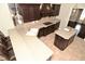 Modern kitchen with expansive countertops, dark wood cabinets, island sink, and stylish pendant lights at 1358 Rutherglen Ct, Danville, IN 46122