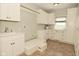 Well-lit laundry room with white cabinetry, sink, and storage space at 1358 Rutherglen Ct, Danville, IN 46122