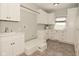 Functional laundry room with white cabinets, countertop space, sink and natural light at 1358 Rutherglen Ct, Danville, IN 46122
