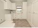 Functional laundry room with ample storage, countertop space, and natural light at 1358 Rutherglen Ct, Danville, IN 46122