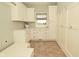 Bright laundry room featuring white cabinetry, storage, and a window at 1358 Rutherglen Ct, Danville, IN 46122