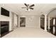 Open-concept living room with fireplace, decorative columns, and views to staircase at 1358 Rutherglen Ct, Danville, IN 46122