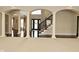 Spacious living room featuring elegant archways, hardwood floors, and a staircase at 1358 Rutherglen Ct, Danville, IN 46122