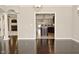 Elegant living room with hardwood floors looking through archway into the kitchen and fireplace at 1358 Rutherglen Ct, Danville, IN 46122