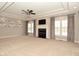 Spacious living room with fireplace, large windows, and tray ceiling at 1358 Rutherglen Ct, Danville, IN 46122