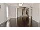 Spacious living room with hardwood floors, archways, and staircase access at 1358 Rutherglen Ct, Danville, IN 46122