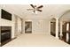 Expansive living room featuring a fireplace, ceiling fan, and open access to other areas at 1358 Rutherglen Ct, Danville, IN 46122