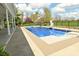 Inviting in-ground pool with a slide, surrounded by lush landscaping and a secure black fence at 1358 Rutherglen Ct, Danville, IN 46122