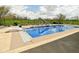 Inviting in-ground pool with a slide and diving board, surrounded by lush landscaping and a secure black fence at 1358 Rutherglen Ct, Danville, IN 46122