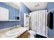 Bathroom featuring blue walls, a vanity, toilet, and shower with a patterned curtain at 1378 Millridge Dr, Greenwood, IN 46143