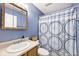 Bathroom featuring blue walls, a vanity, toilet, and shower with a patterned curtain at 1378 Millridge Dr, Greenwood, IN 46143