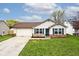 Charming single-story home with a two-car garage, brick accents, and well-maintained lawn at 1378 Millridge Dr, Greenwood, IN 46143
