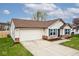 Well-maintained home featuring a 2-car garage, vinyl siding, brick accents, and a green lawn at 1378 Millridge Dr, Greenwood, IN 46143