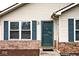 Charming home exterior featuring a front door, blue shutters, and brick accents at 1378 Millridge Dr, Greenwood, IN 46143