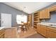 Eat-in kitchen with wood cabinets, built-in shelving, dining table, and bright natural light at 1378 Millridge Dr, Greenwood, IN 46143