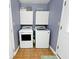 Functional laundry room with a washer, a dryer and built-in cabinets for storage at 1378 Millridge Dr, Greenwood, IN 46143
