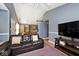 Comfortable living room featuring vaulted ceilings, a large couch, hardwood floors and plenty of natural light at 1378 Millridge Dr, Greenwood, IN 46143