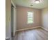 Bedroom features include a large window, light-colored walls, and wood-look flooring at 1509 E Centennial Ave, Muncie, IN 47303