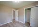 This neutral bedroom has light walls, wood-look flooring and a roomy closet at 1509 E Centennial Ave, Muncie, IN 47303