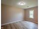Bedroom with light walls, hardwood floors, and a bright window at 1509 E Centennial Ave, Muncie, IN 47303